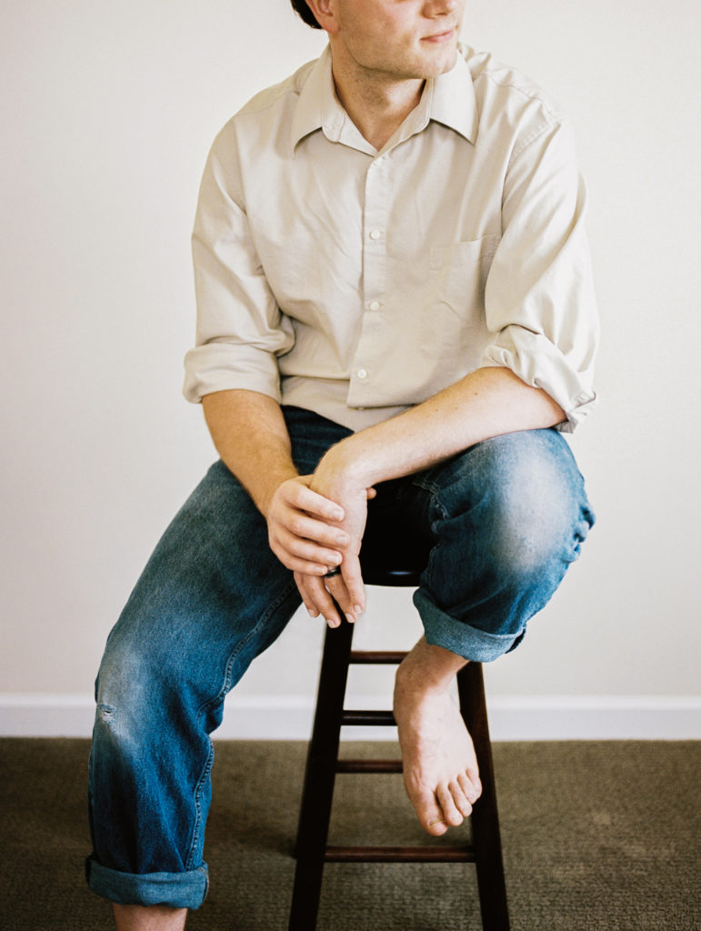 image of a man sitting on a stool for an easy film photography course