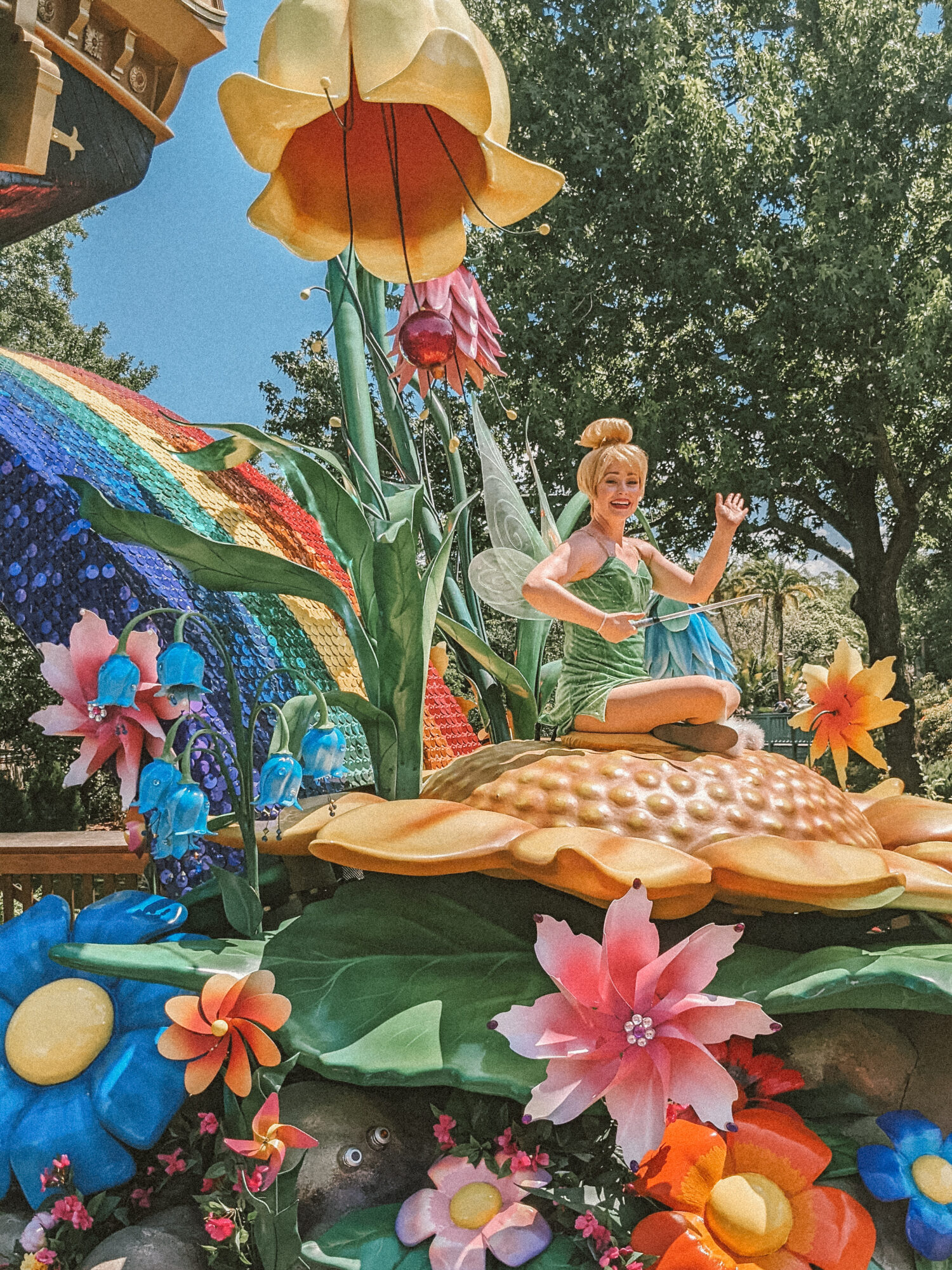 tinker bell on a parade float at disney world